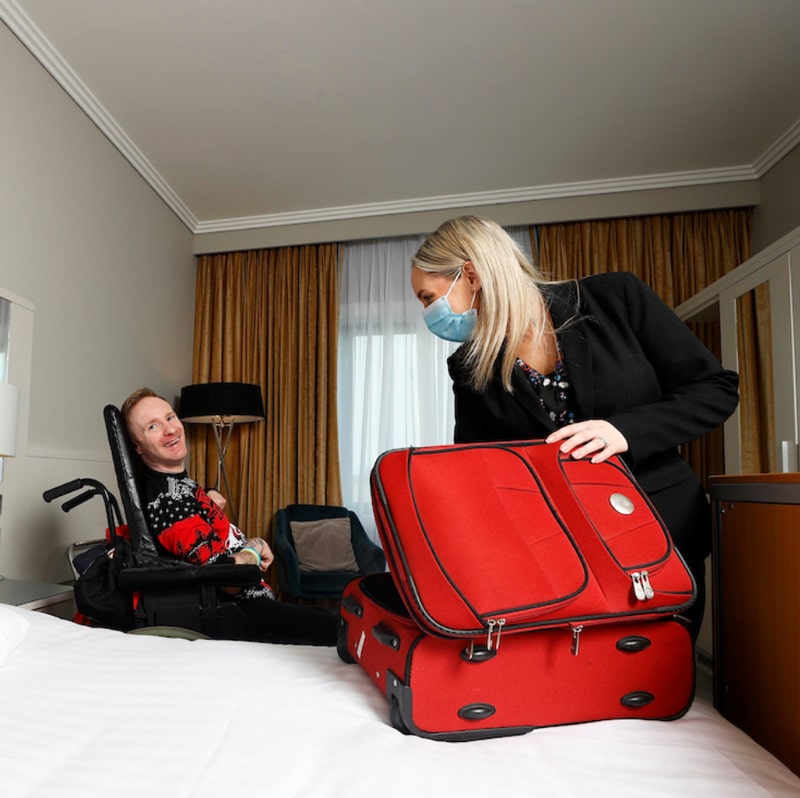 shearwater hotel image showing guest unpacking bag by assistance person